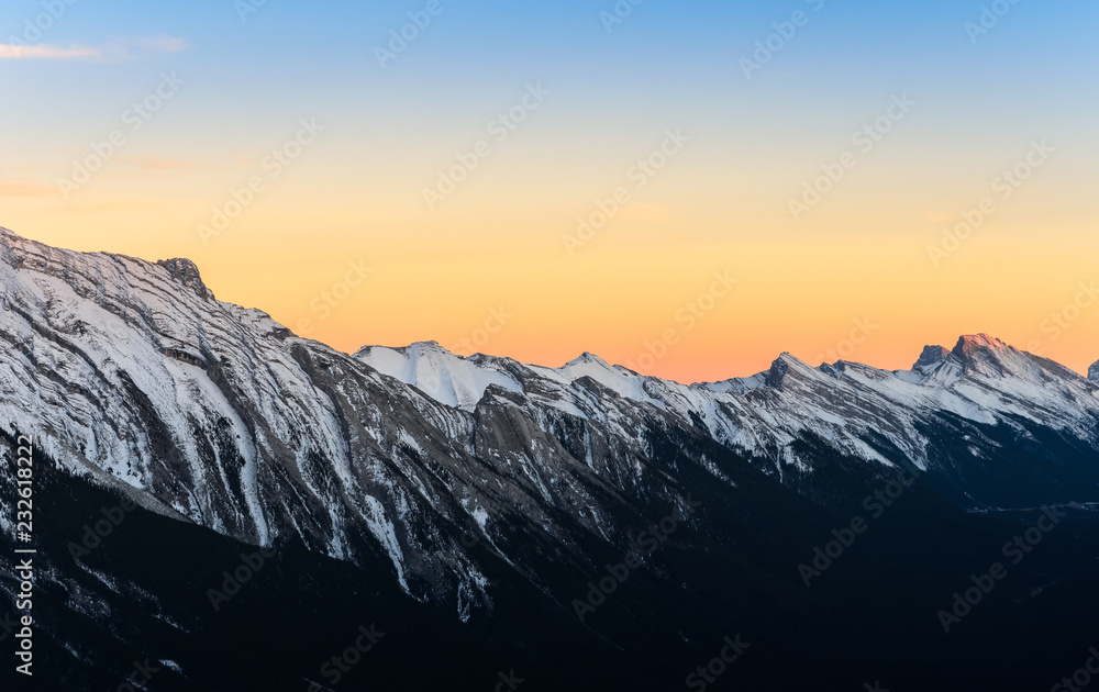 Beautiful sunset view of snow capped Rocky mountains at Banff National Park in Alberta, Canada.