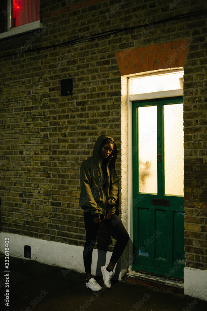 Woman leaning at wall at night Woman leaning at wall at night