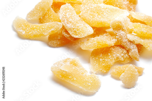 Slices of crystallized ginger in sugar isolated on white