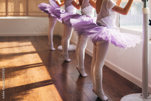 Children practicing ballet poses in ballet studio photo