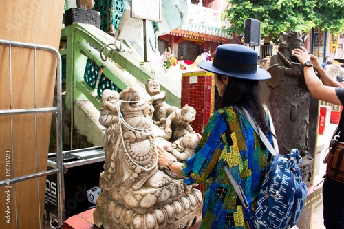 Thai woman visit and respect praying Katyayana or Gautama Buddha of Tin Hau Temple at Repulse Bay in Hong Kong, China photo