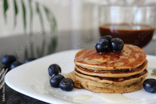 Banana, oat and eggs Pancakes with Blueberries and agave syrup. Healthy and vegetarian breakfast.