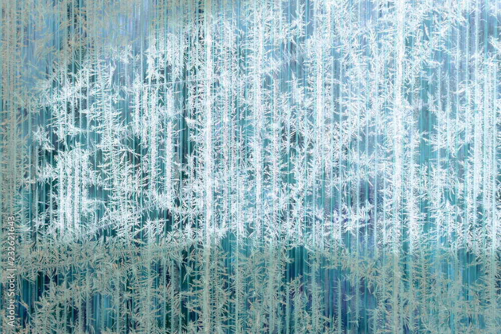 Frosty pattern of hoarfrost and snowflakes on striped glass, winter or Christmas background, texture Frosty pattern of hoarfrost and snowflakes on striped glass, winter or Christmas background, texture