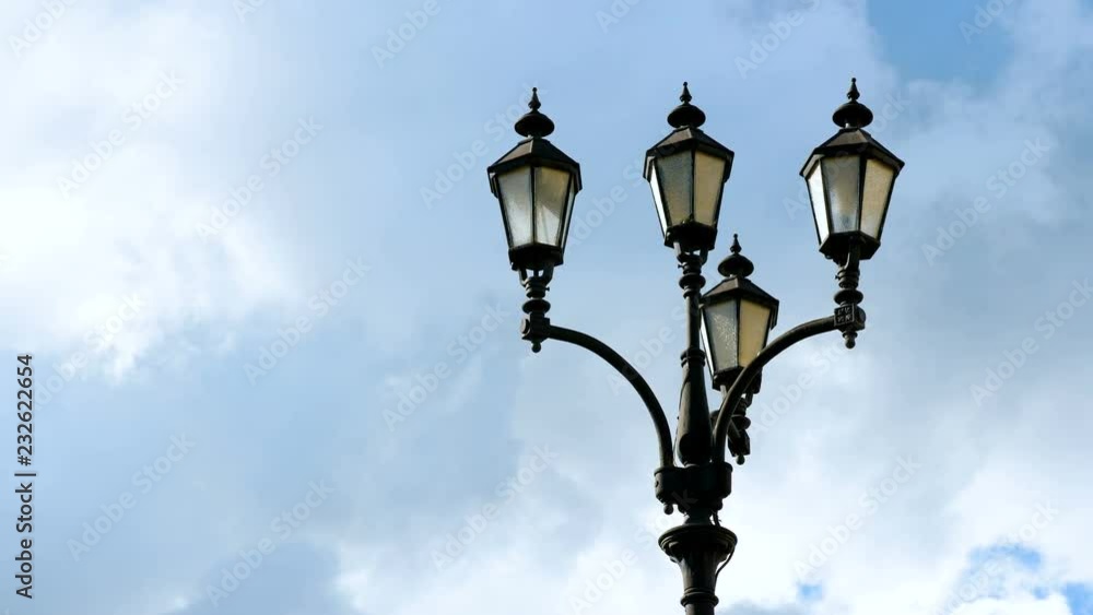 Black street lamp against a cloudy sky in the daytime. Black street lamp against a cloudy sky in the daytime.