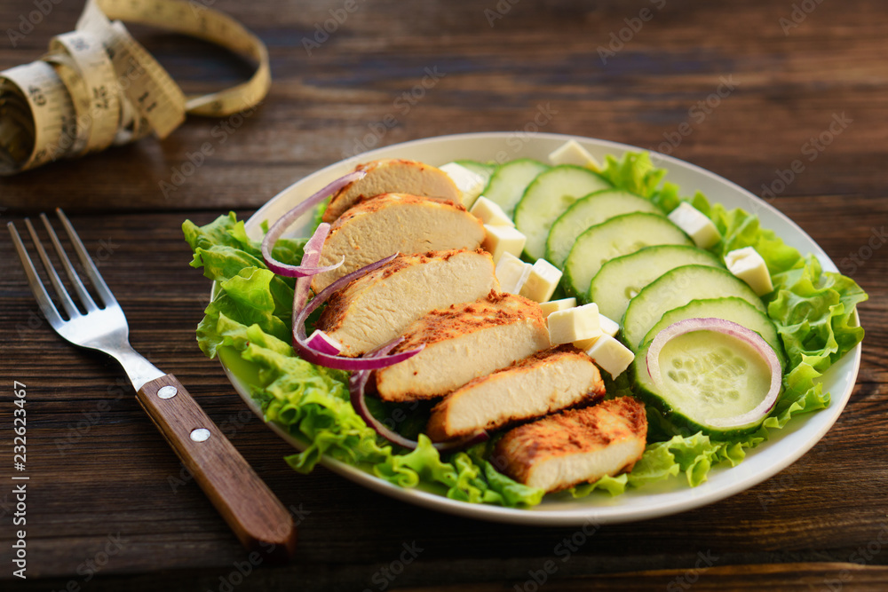 diet, healthy lifestyle, low calorie food, keto, proteins, low fat. Baked chicken breasts with vegetables and measuring tape diet, healthy lifestyle, low calorie food, keto, proteins, low fat. Baked chicken breasts with vegetables and measuring tape
