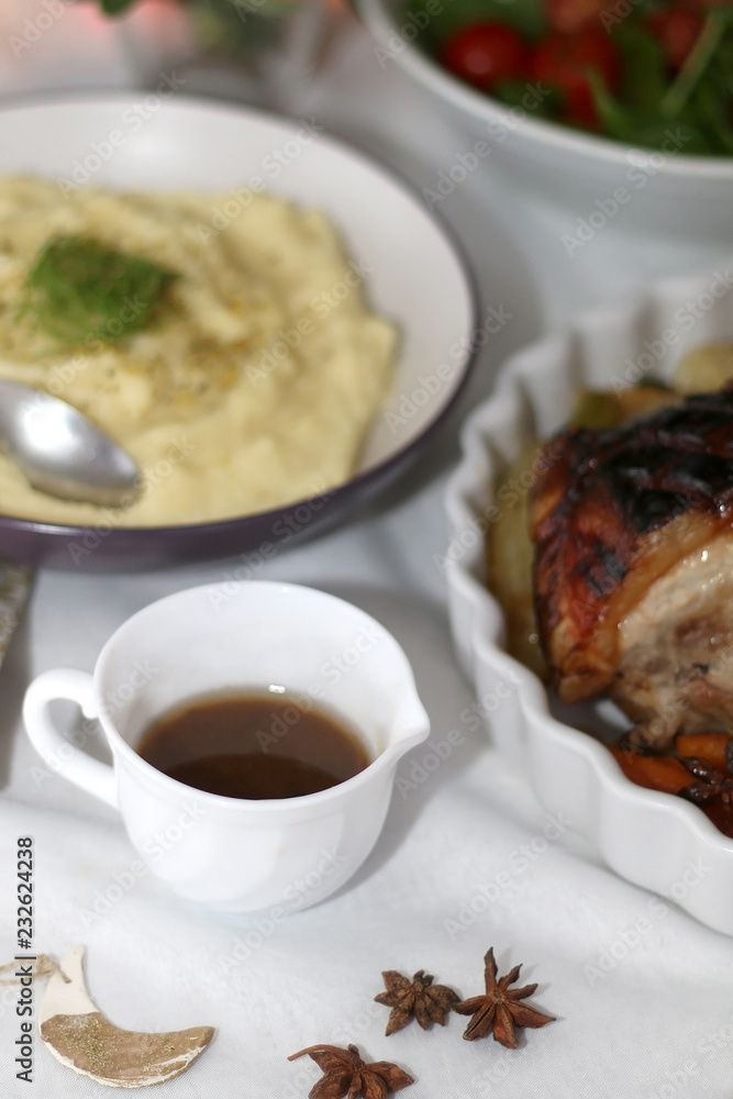 Gravy and mashed potato on a holiday table. Selective focus.