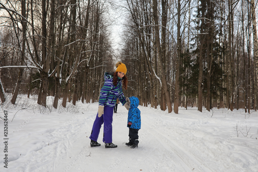 Kid with family have fun in a  winter park