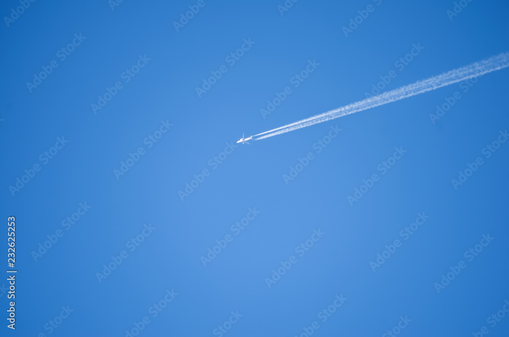 Airplane leaves chemical traces in the blue sky Airplane leaves chemical traces in the blue sky