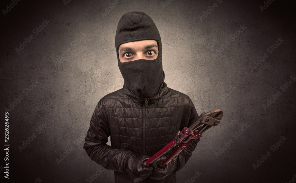 Burglar standing in black clothes and balaclava on his head. Burglar standing in black clothes and balaclava on his head.
