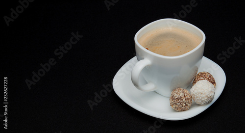 Coffee cup, beans, chocolate and macaroons on old kitchen table. Top view with copyspace for your text