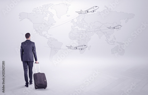 Businessman in dark suit planning his trip in a front of a map 