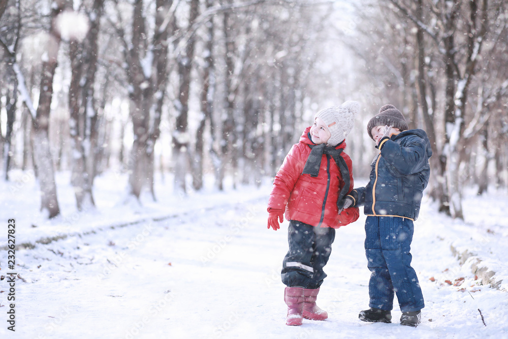Kids walk in the park first snow Kids walk in the park first snow