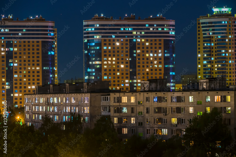night panoramic view of traffic and Windows of houses on the outskirts of the metropolis