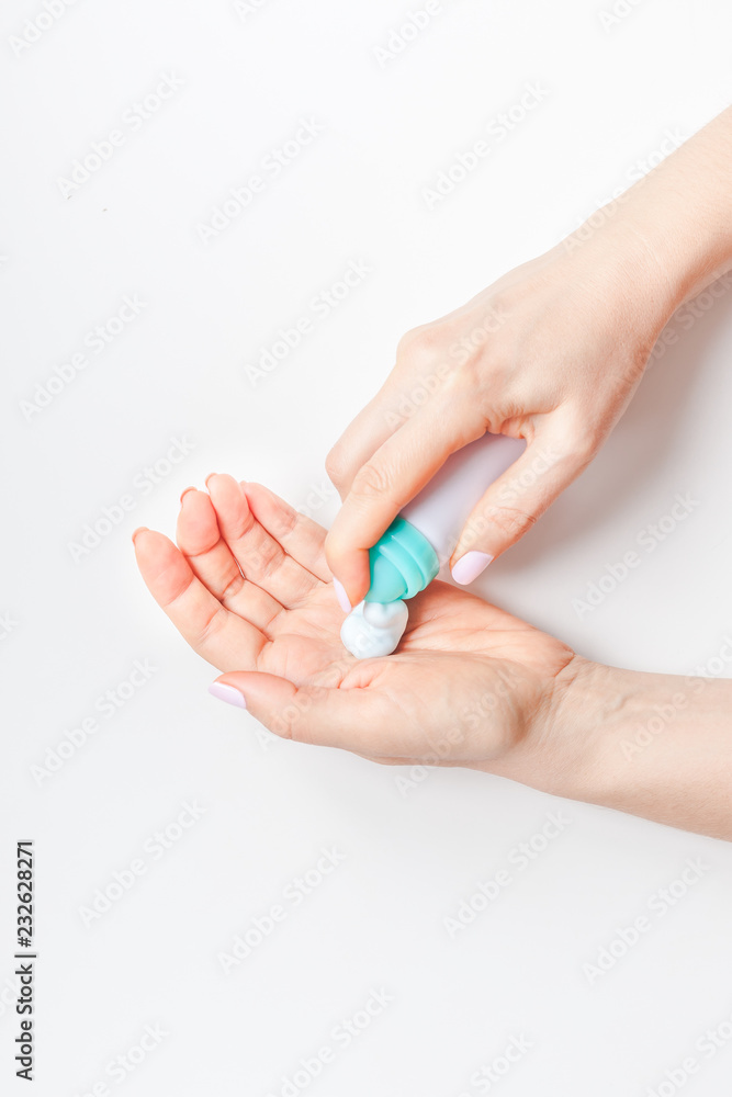 Woman moisturizing her hands with foam lotion Woman moisturizing her hands with foam lotion