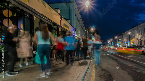 people have fun on the city streets on a summer evening on Saturday