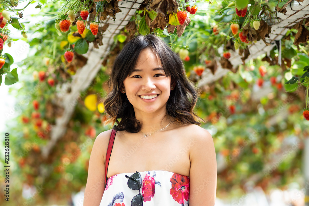 Young woman at a strawberry farm Young woman at a strawberry farm