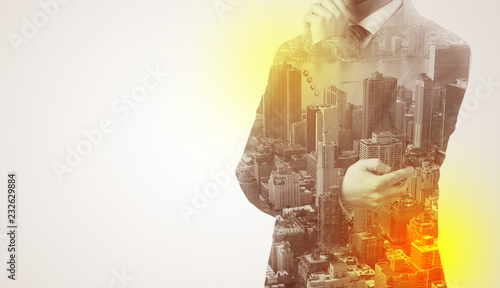 Businessman in suit standing thinking with metropolis graphic 