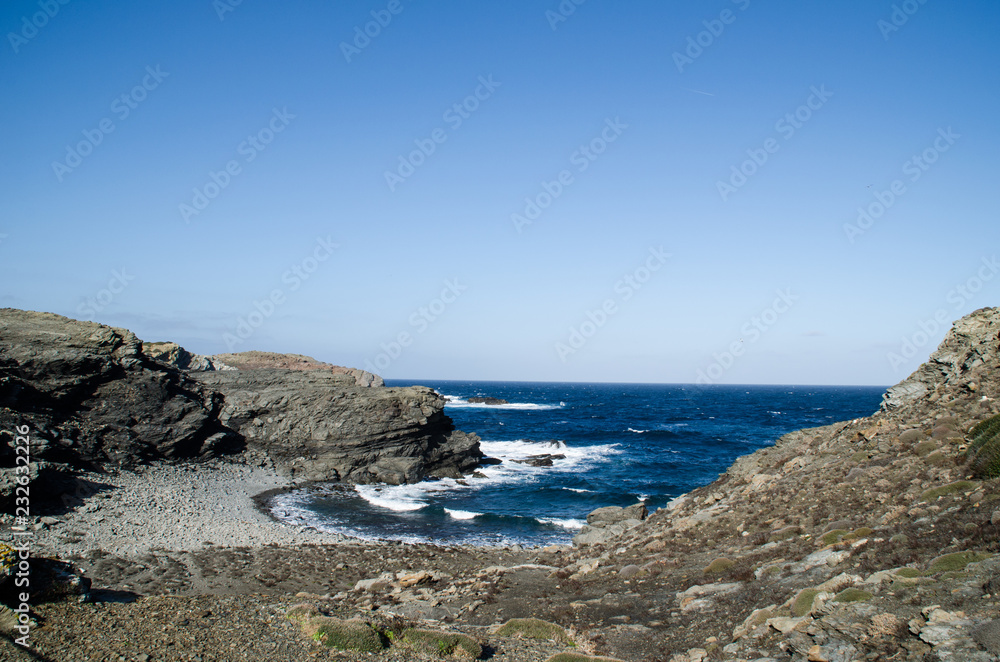 Photograph of a landscape with a view of the sea from a rocky coast.