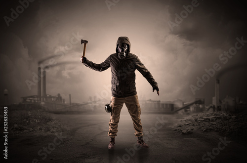 Gas masked survival man coming with arms on his hand  in a demolished dark environment   © ra2 studio