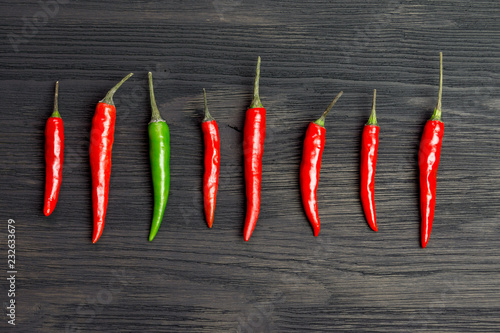 Seven red and one green hot pepper