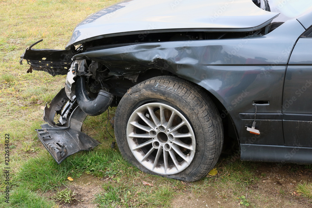 The front of a crashed broken passenger car The front of a crashed broken passenger car