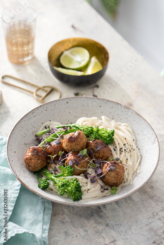 Soy glazed meatballs over chow mein noodles. photo