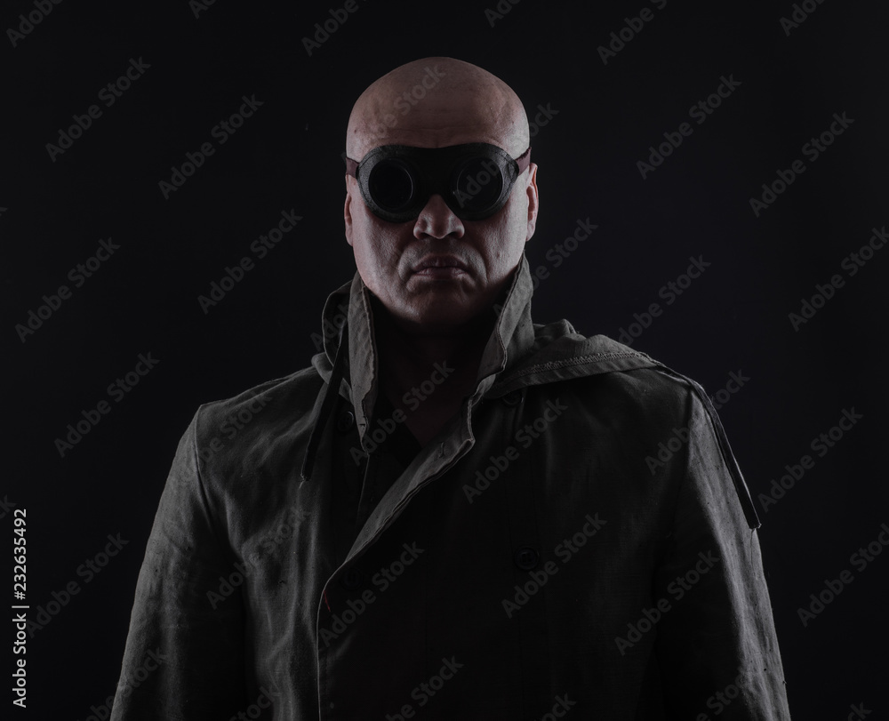 bald man with glasses on a black background bald man with glasses on a black background