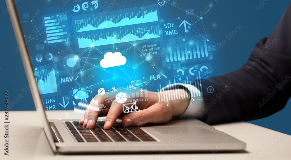 Businessman hand typing on laptop with reports and graphs concept around
Businessman hand typing on laptop with reports and graphs concept around