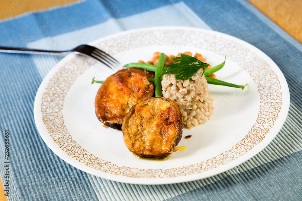 Fototapeta premium Fried breaded aubergine and barley pearl.