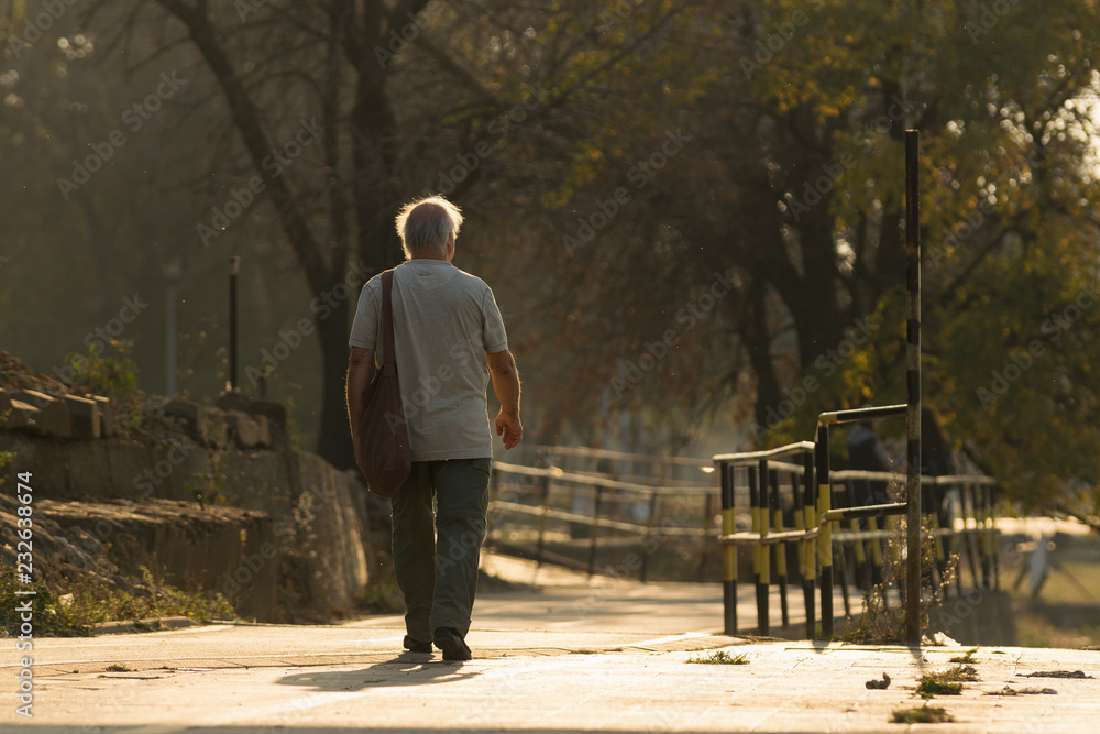 Old man walking. Pensioner lifestyle.
