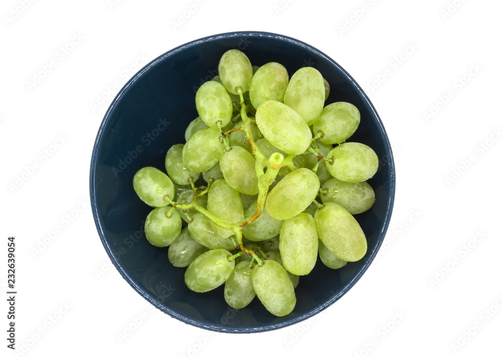Bunch of green grapes in a plate isolated on white background