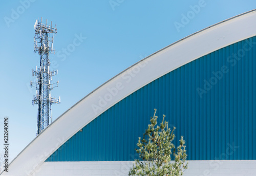 Cell Phone tower obscured by building photo