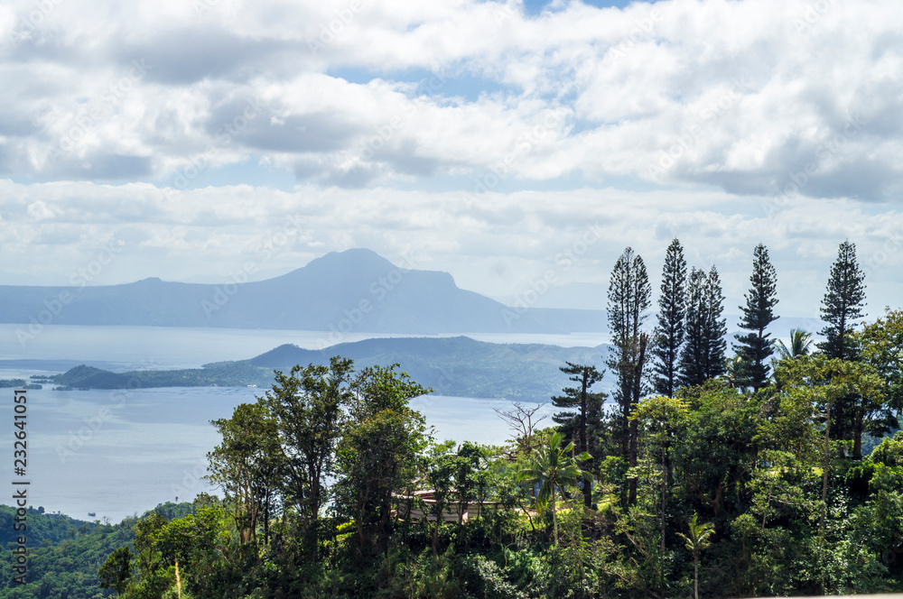 Trees on Hilltop Overlooking Lake and Volcano