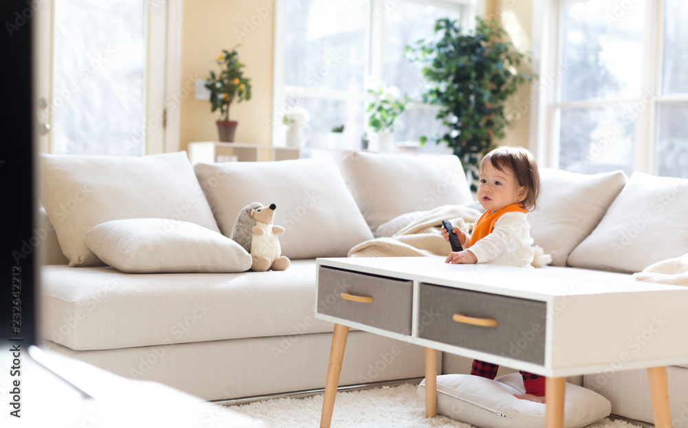 Little toddler boy with a TV remote control Little toddler boy with a TV remote control