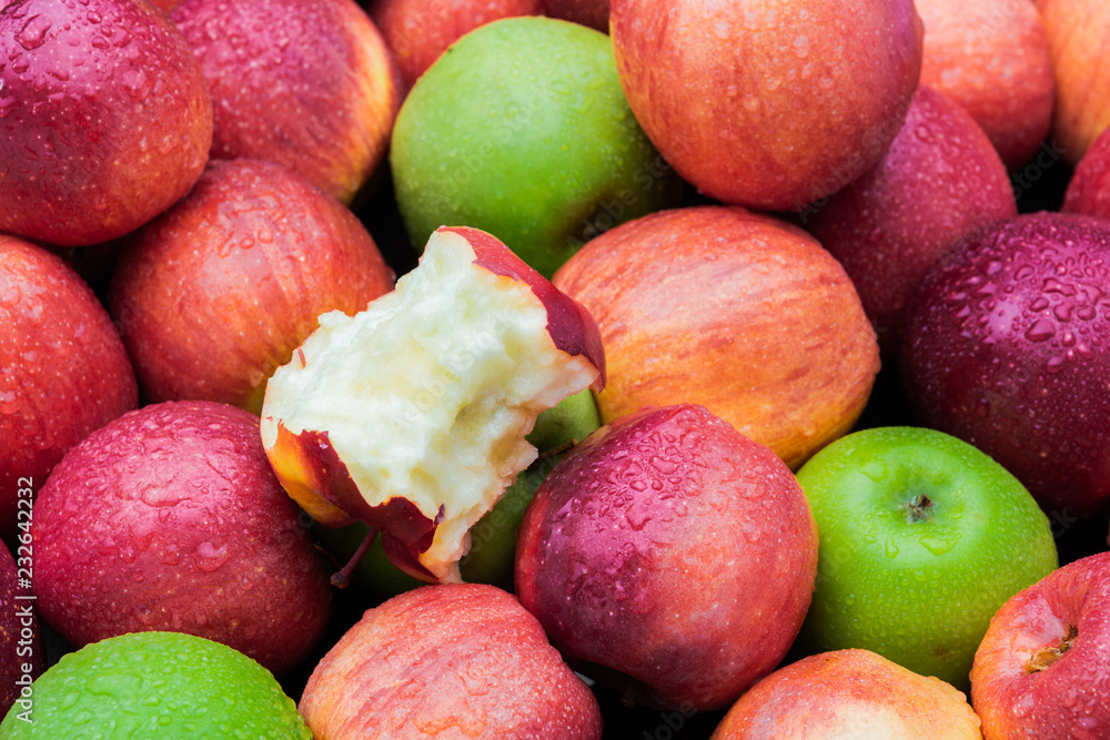 Apple core leftover among heap of fresh red and green apples mix closeup side view Apple core leftover among heap of fresh red and green apples mix closeup side view