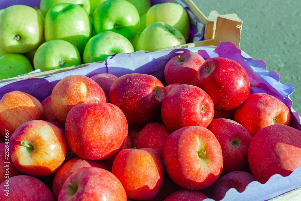 heap of unwashed green and red apples mix on wooden background, top side view closeup