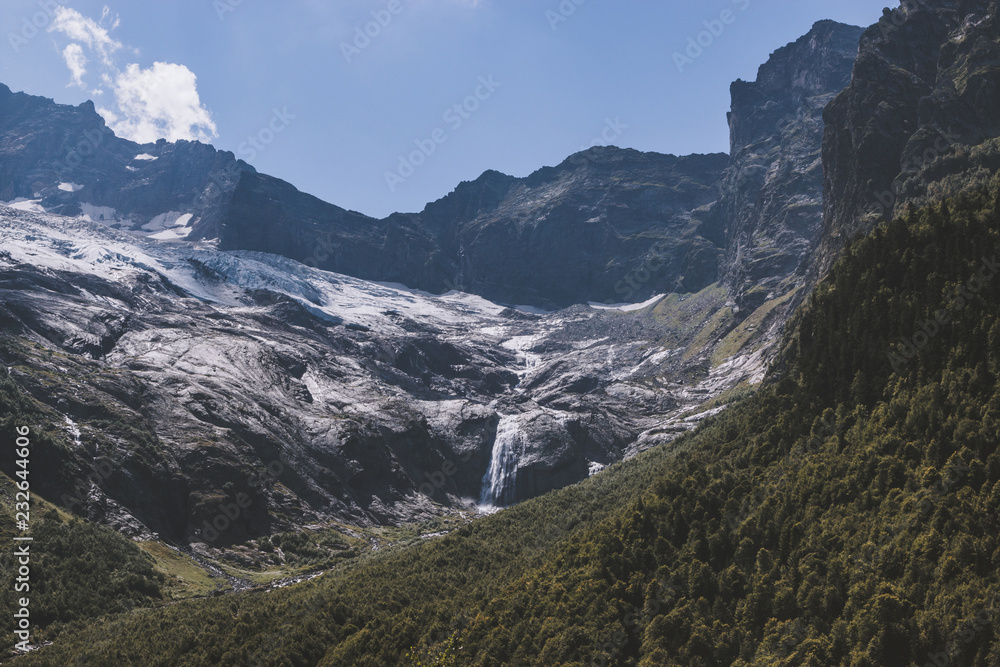 Closeup view mountains scenes and far away waterfall in national park of Russia