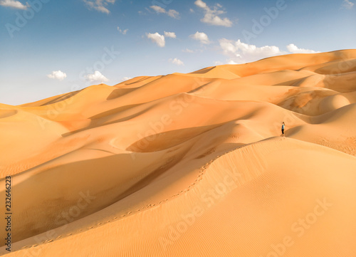 person in Liwa desert, part of Empty Quarter, the largest continuous sand desert in the world