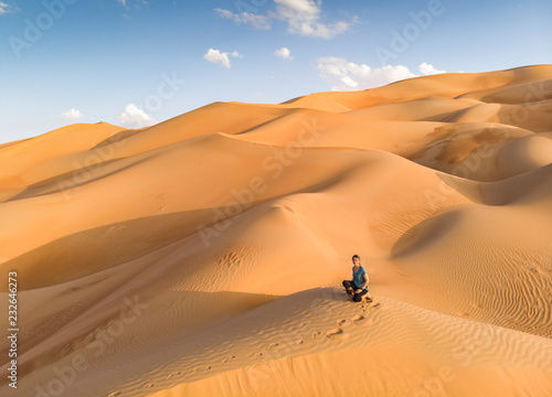 person in Liwa desert  part of Empty Quarter  the largest continuous sand desert in the world
