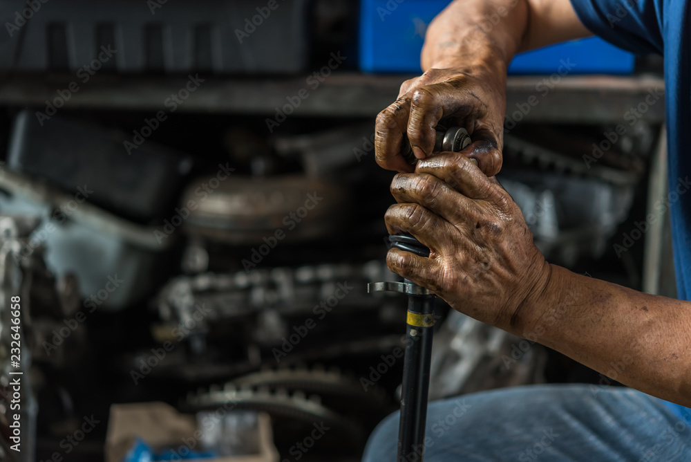 Checking a car suspension for repair at car garage Checking a car suspension for repair at car garage