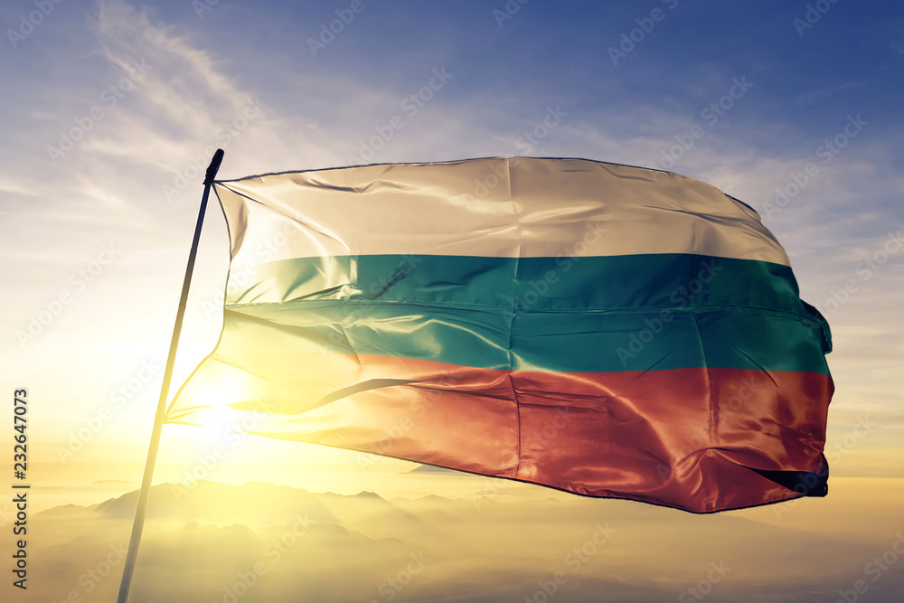 Bulgaria Bulgarian flag textile cloth fabric waving on the top sunrise mist fog