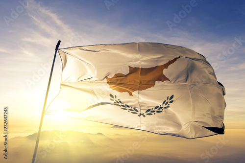 Fotografie Cyprus Cypriot flag textile cloth fabric waving on the top sunrise mist fog