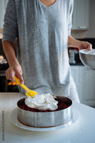 A young girl cooks in her kitchen