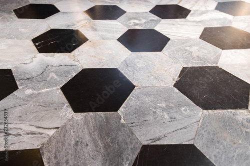 Old decorative floor in marble. Black and gray.