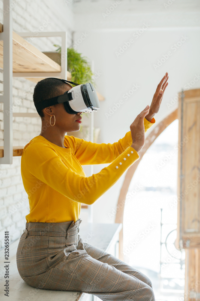 Woman wearing virtual reality headset at office. Woman wearing virtual reality headset at office.