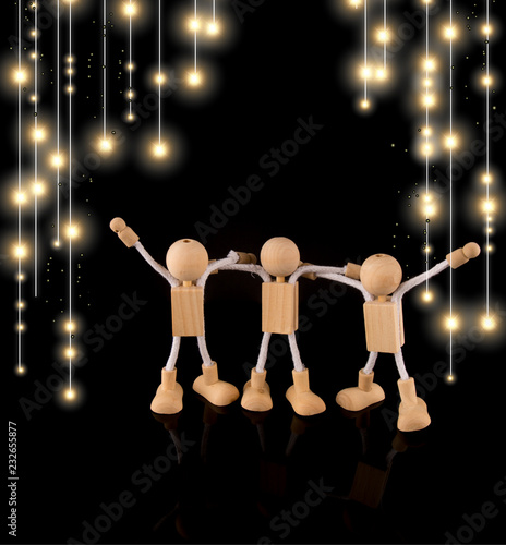Party, friends , Wooden Stick Figures team isolated on bokeh lights black background, copy space © AnnJane