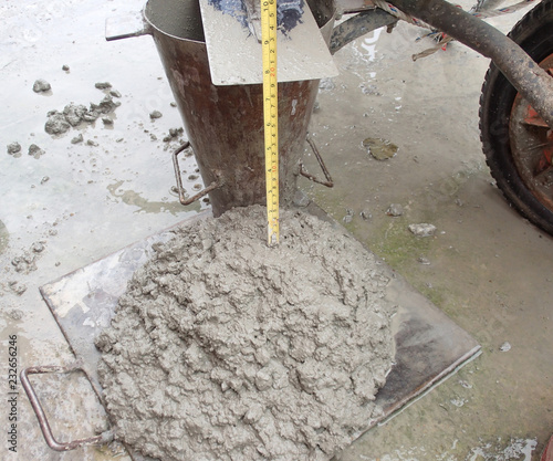 Foto Construction workers doing slump test using specific equipment at the construction site