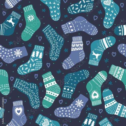 Winter pattern from hand drawn cute warm socks on dark blue background. Vector illustration.