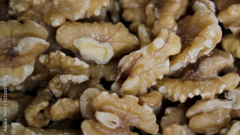 Hand takes a Walnut from rotation Walnut kernels Hand takes a Walnut from rotation Walnut kernels