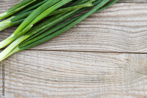 Fresh green onion on rustic wooden table